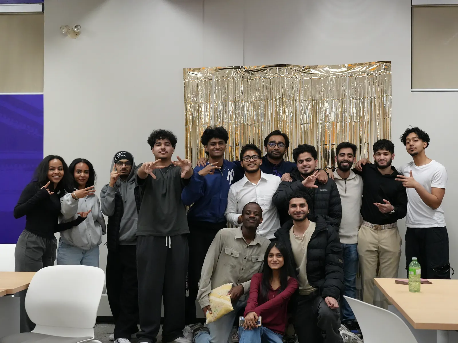 A group photo in front of a gold tinsel backdrop at Soco Hoco, March 2026.
